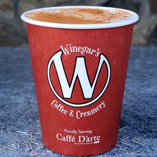 A Winegar's latte in a red cup